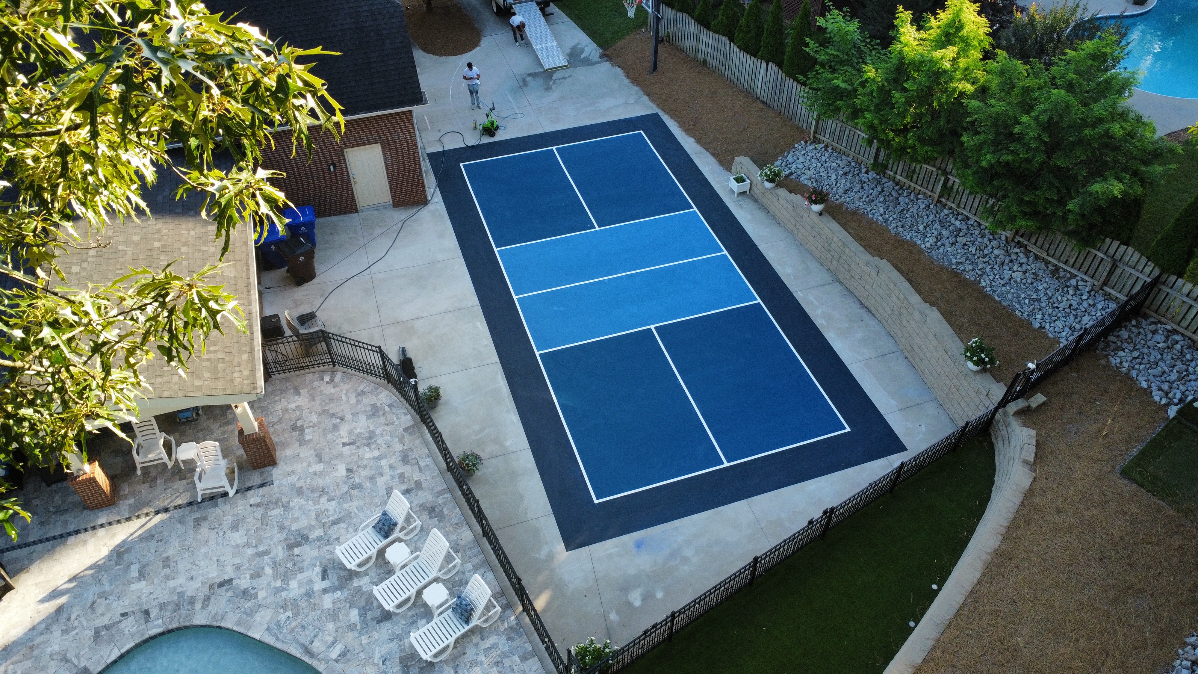 Finished residential pickleball court blue dark outdoor aerial