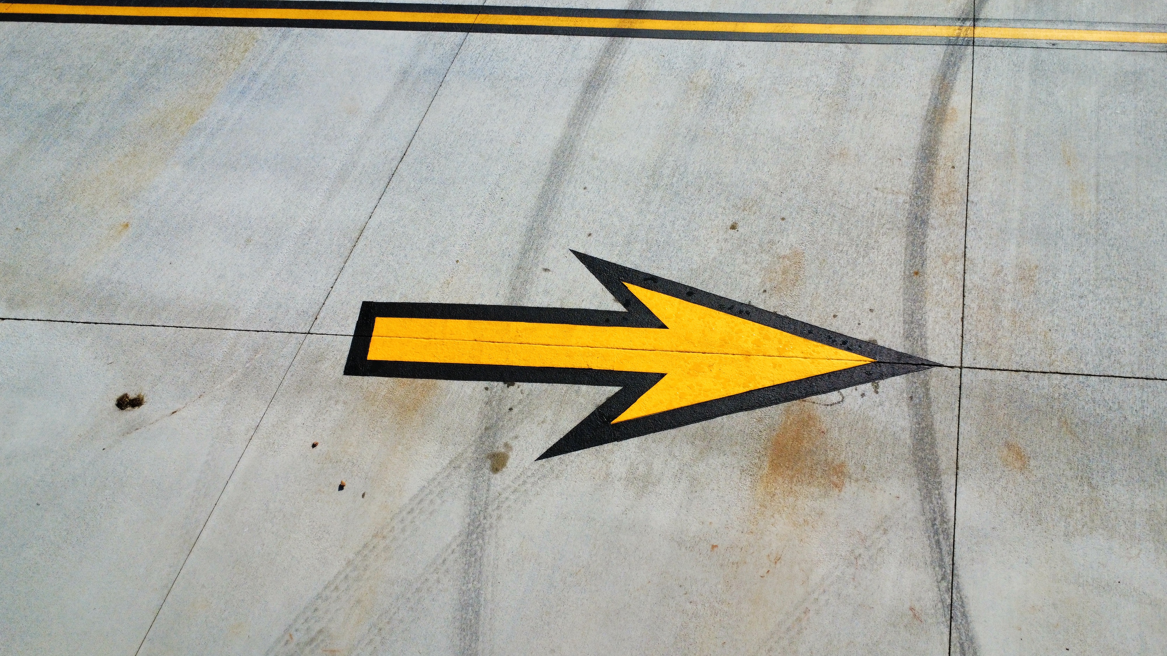 RaceTrac thermoplastic yellow arrows fuel station aerial