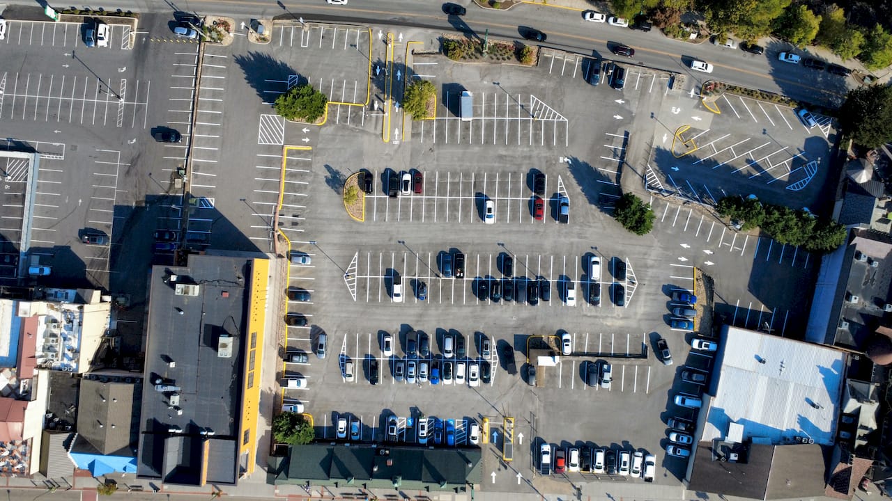 Commercial parking lot full sealcoat yellow striping aerial