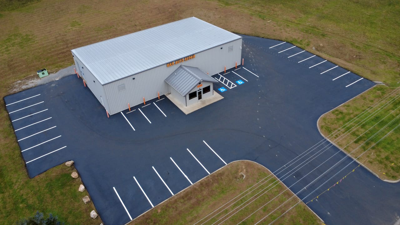 Auto repair parking lot new asphalt sealcoating aerial