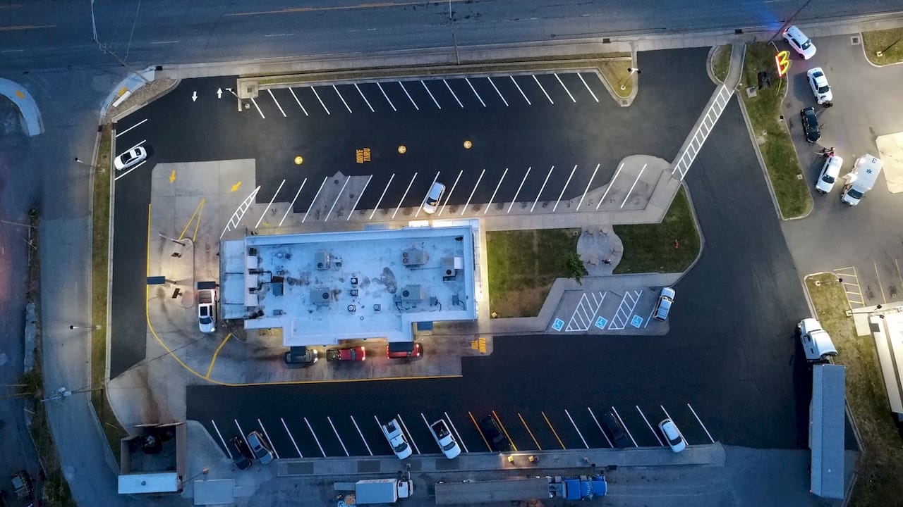 McDonald's parking lot sealcoating night aerial — Pinnacle Pavement Solutions