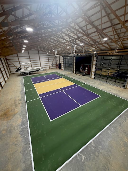 Indoor pickleball court purple gold barn boat garage